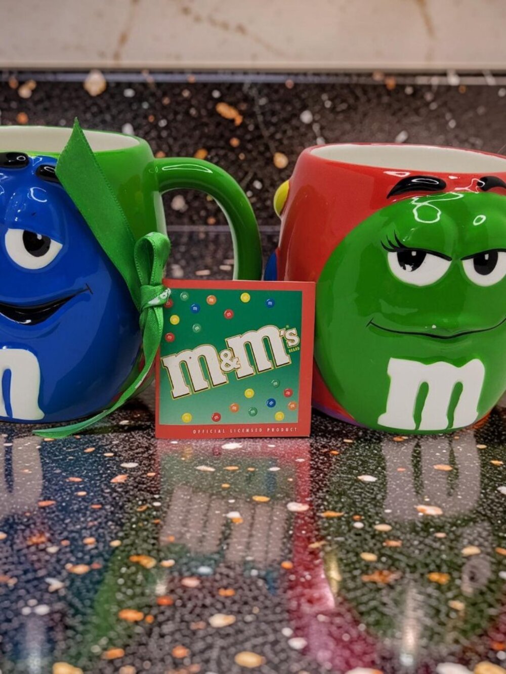vintage galerie 2002 pair of blue m&m and green m&m ceramic coffee mugs.